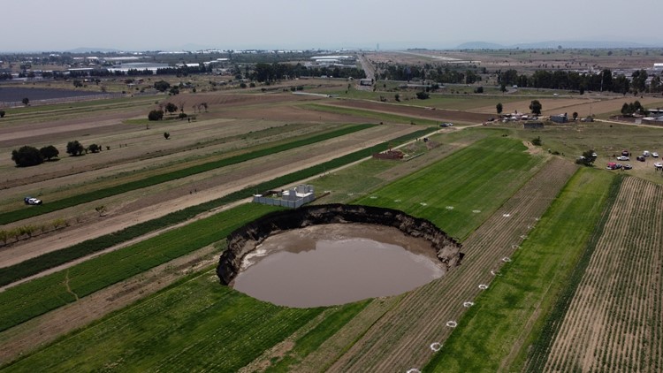 Sinkhole at Mexico farm swallows more land, traps 2 dogs