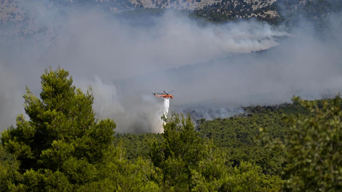 Firefighters battle wildfire west of Athens as strong winds fuel