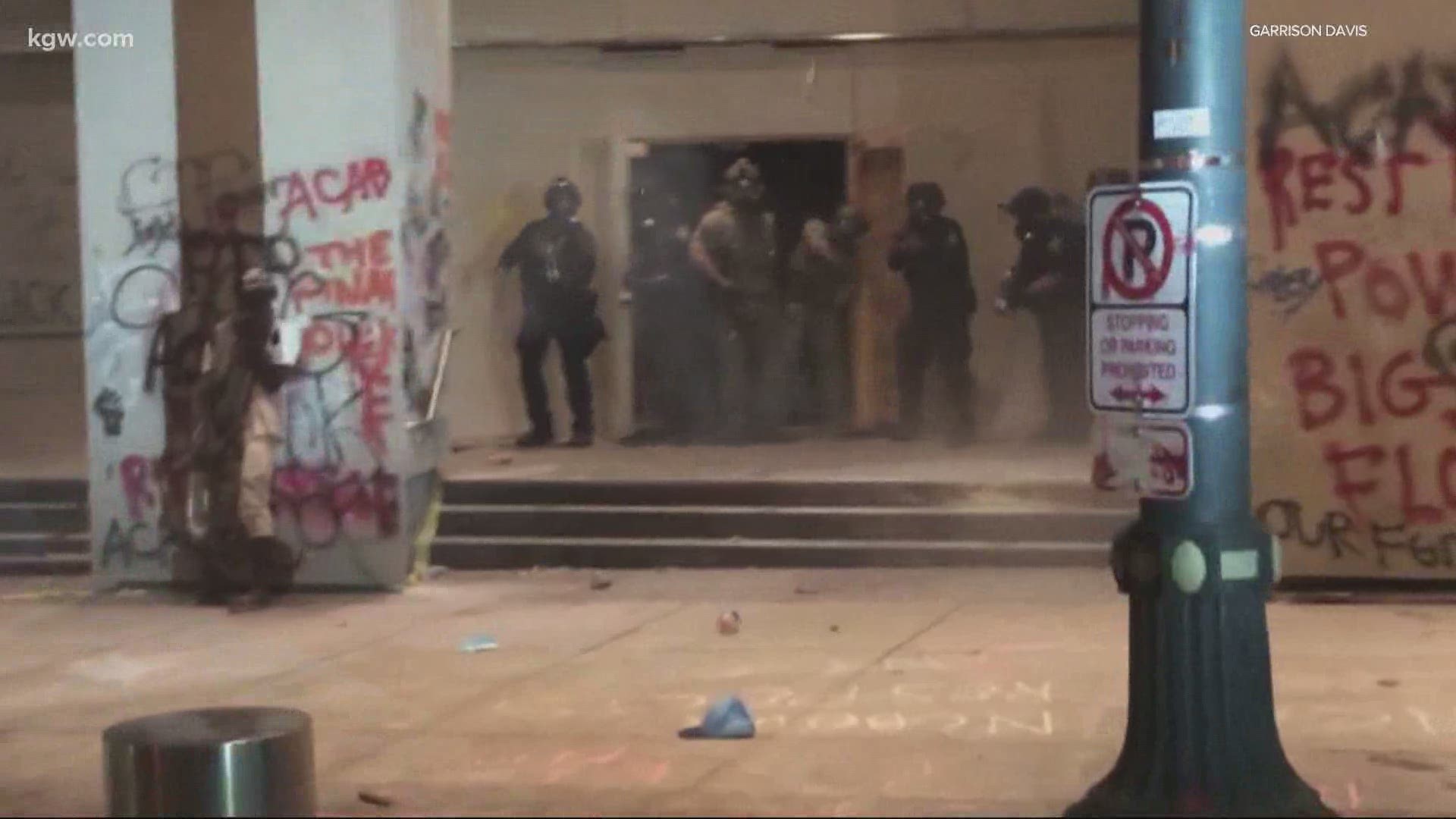 A protester standing across the street from the federal courthouse was hit in the head by what appeared to be an impact munition fired by a federal officer.