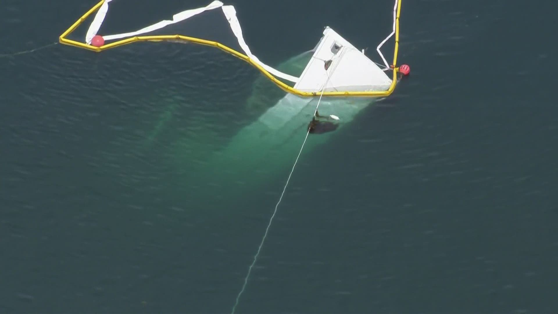 The hull on John Wayne's former yacht is severely damaged. The vessel has been at least semi-submerged for days.