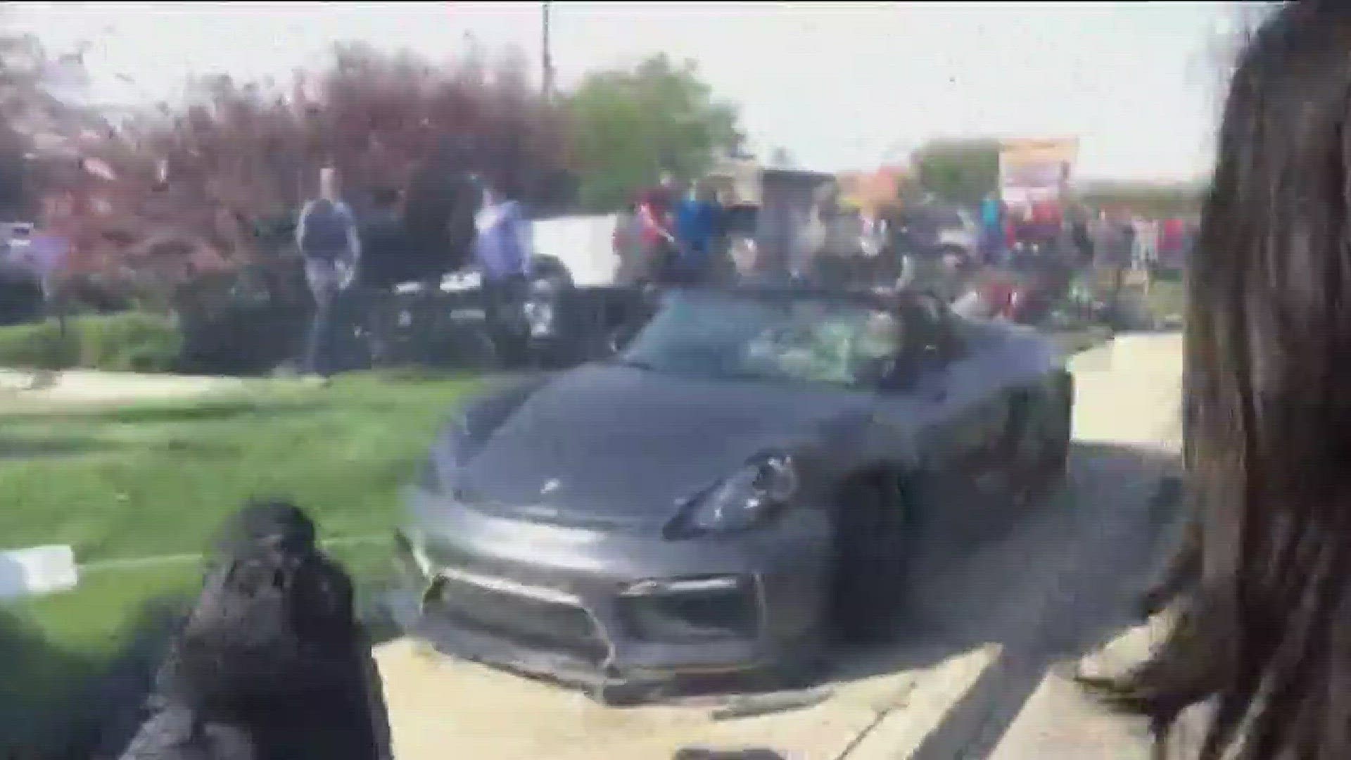 Police say the driver of a Porsche Spyder accelerated rapidly while leaving the Cars and Coffee event and lost control of his car, which went into the crowd.