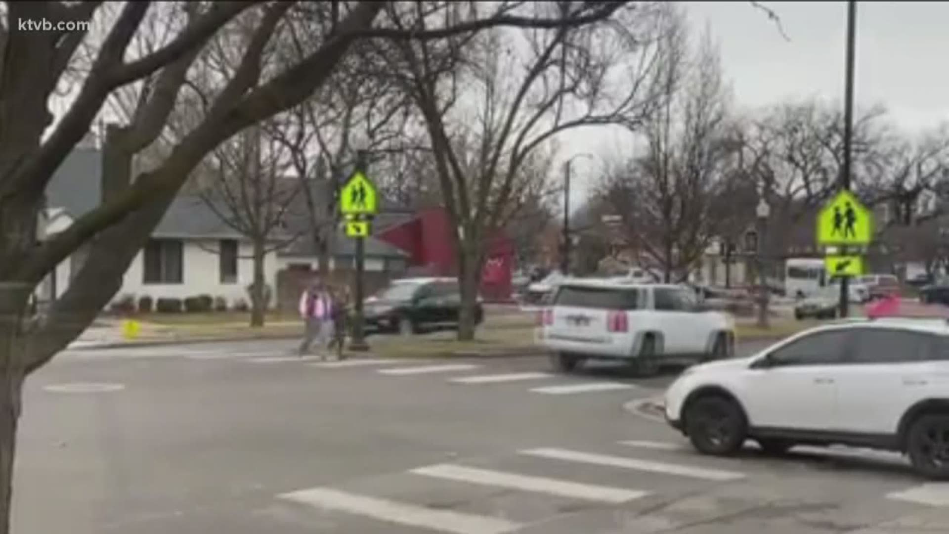 The video has parents pretty fired up. It shows children walking in a crosswalk as cars continue to drive on through.