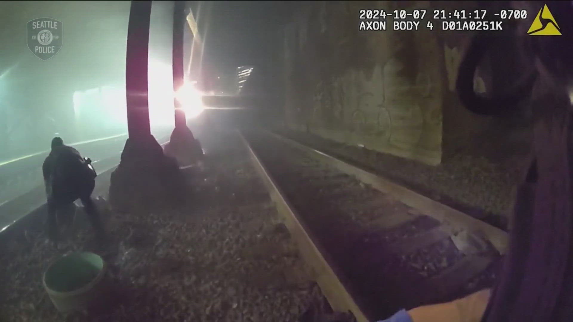 Video from the Seattle Department Police shows officers running onto the tracks and pulling the man away from the oncoming train.