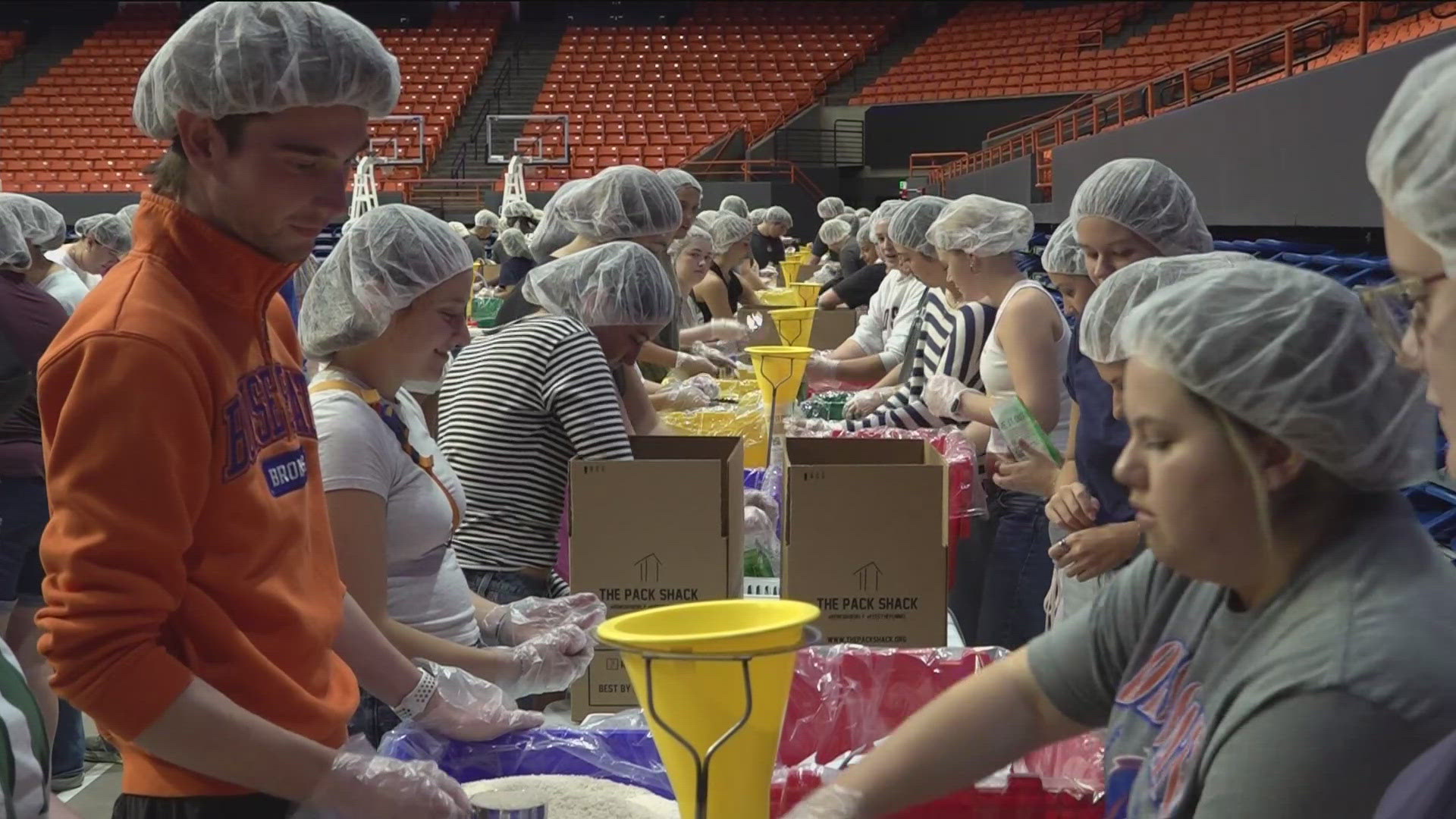 Hundreds of people packed Extra Mile Arena Friday to pack roughly 75,000 meals for food banks in the Gem state.