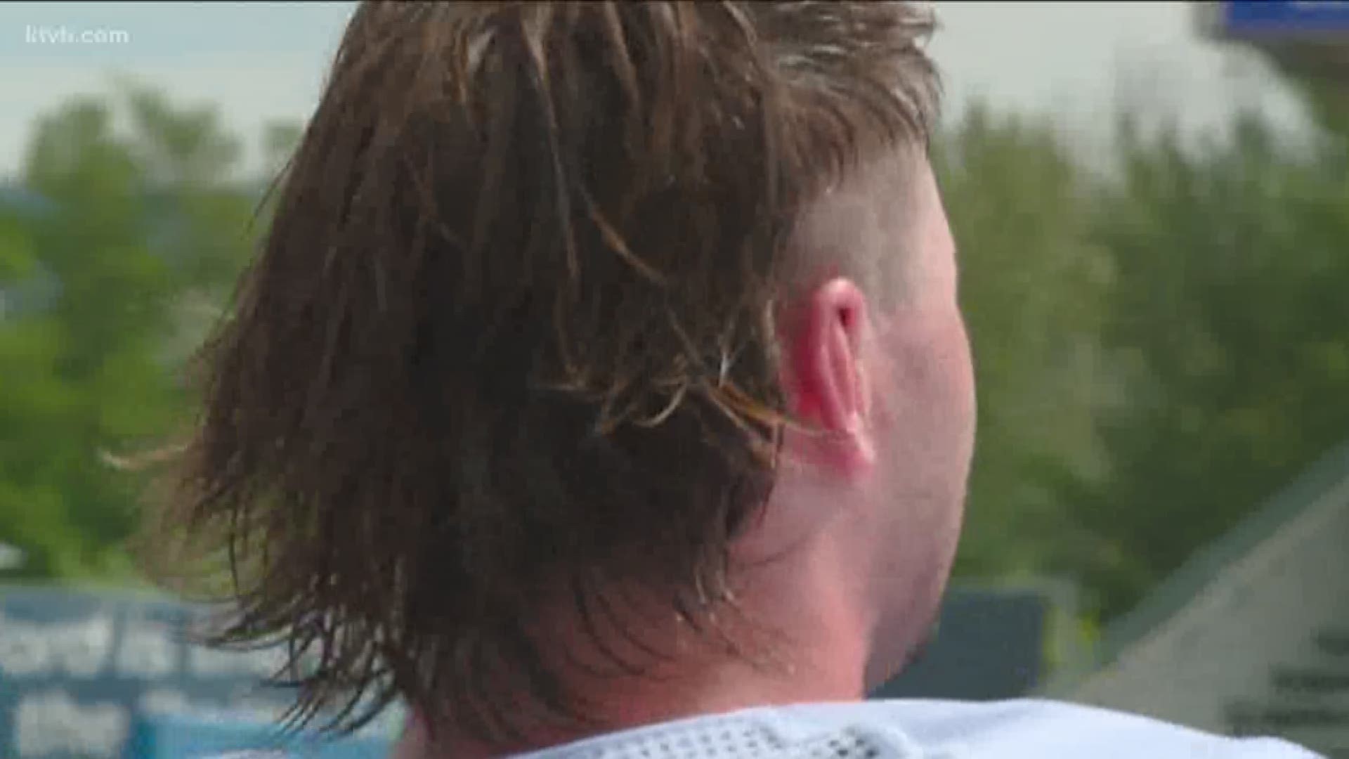 Boise State's Jon Mulchon shows off his summer mullet during fall camp.
