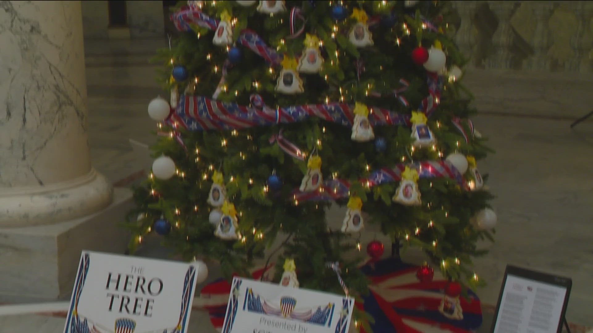 The 'Hero Tree' is adorned with ornaments to honor Idaho's fallen military heroes. It is located in the Idaho Capitol Rotunda by the Idaho Attorney General's Office.