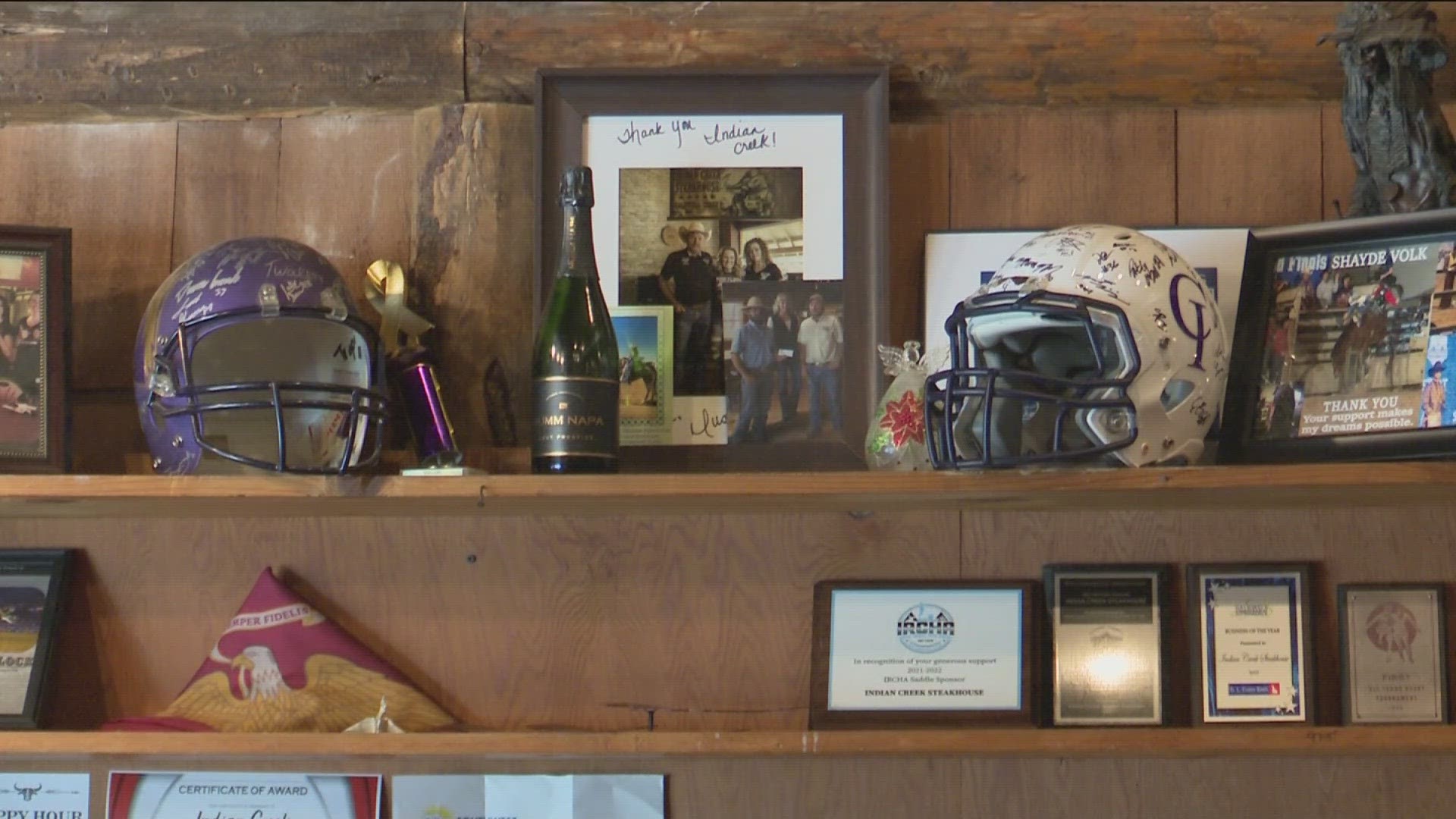 The item is back on display at Indian Creek Steakhouse. It joins a new Yotes helmet signed by the current football team after the gold one was stolen.