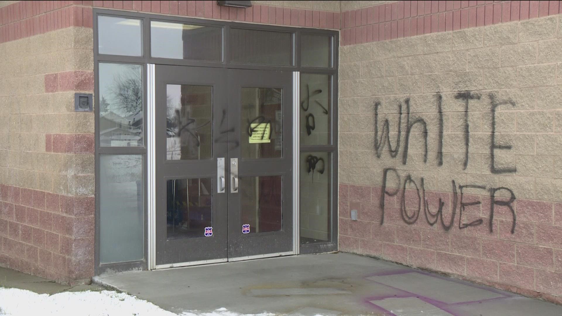Following a student protest, the high school was graffitied with hateful terms by four hooded individuals.