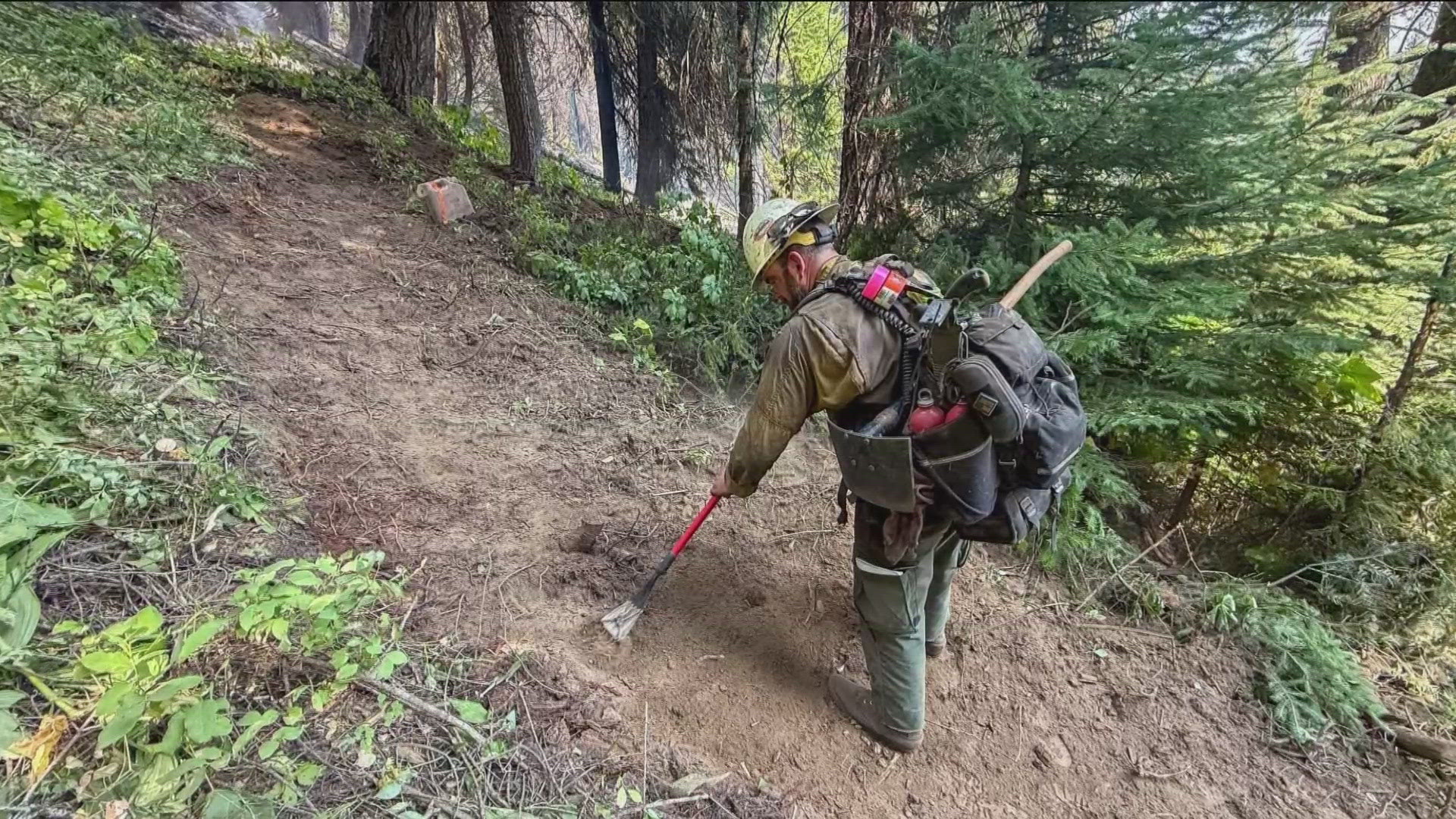The wet weather has helped fire crews, allowing them to downgrade evacuation orders in the West Mountain area.