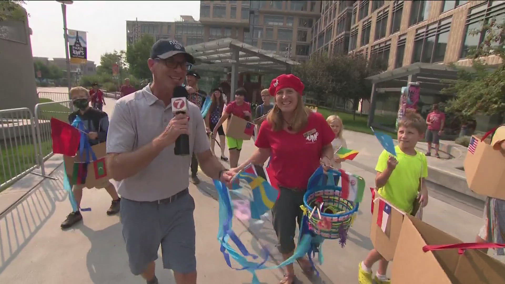 The Journey Through JUMP Kids Camp strolls through downtown Boise in a cardboard boat and flag parade alongside KTVB's Brian Holmes.