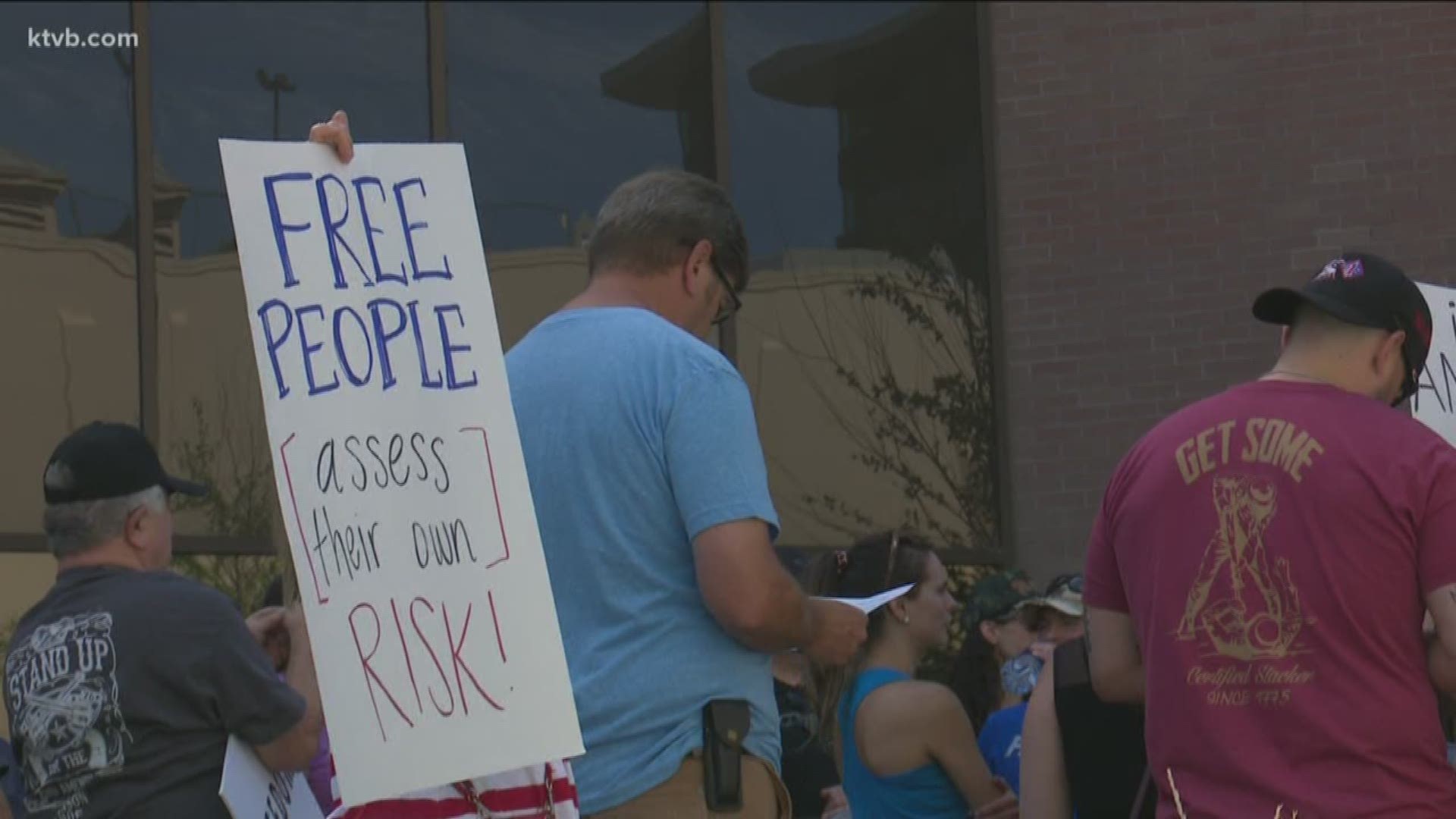 While members of Boise's city council handed out masks to those in need of them, protesters gathered at City Hall to fight the city's public health mandate.