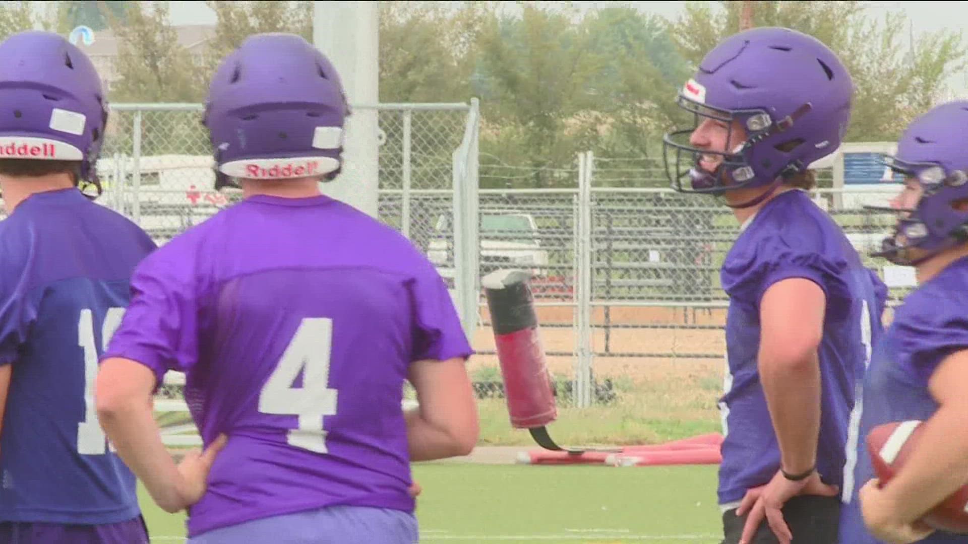Ryan Hibbs (left) and Andy Peters (right) stand on the sidelines at the Yotes' first day of practice