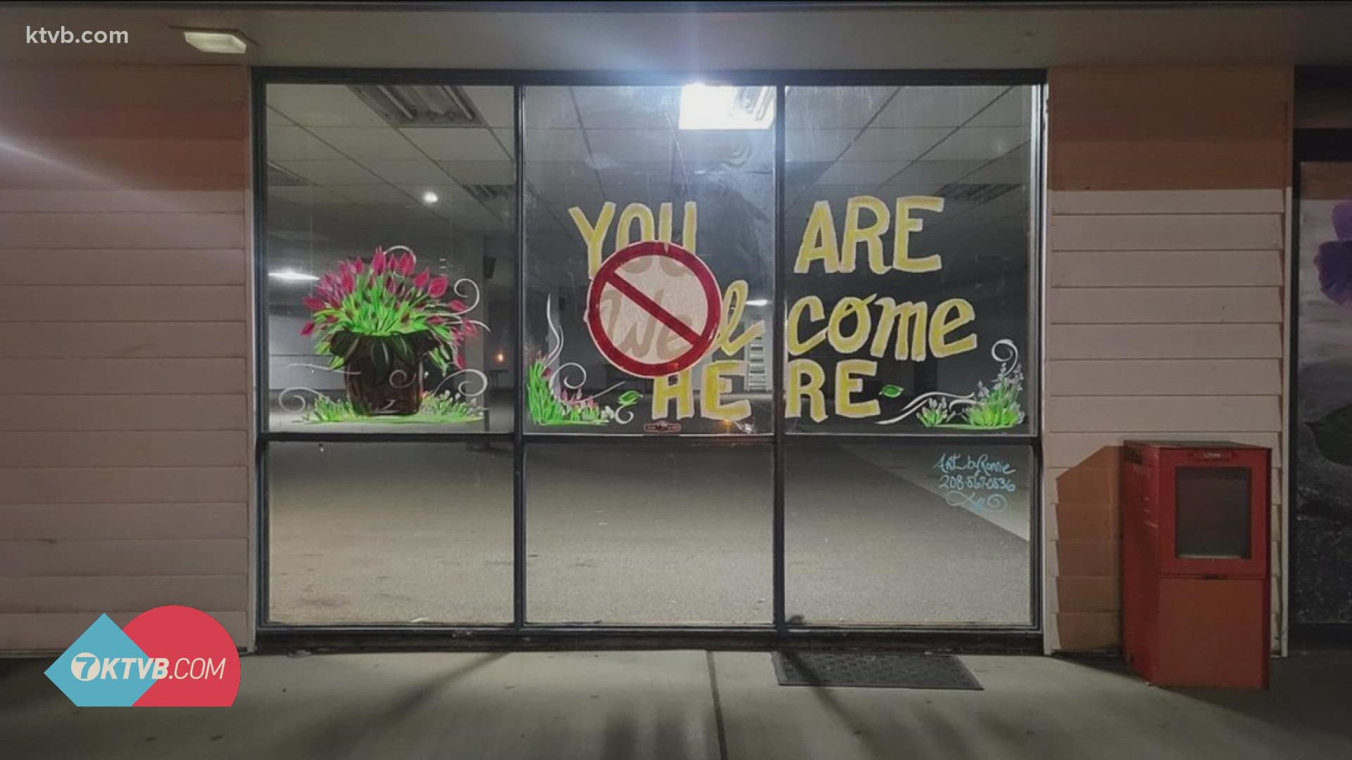 The message "You Are Welcome Here" was defaced with a large symbol effectively crossing out the word "welcome."