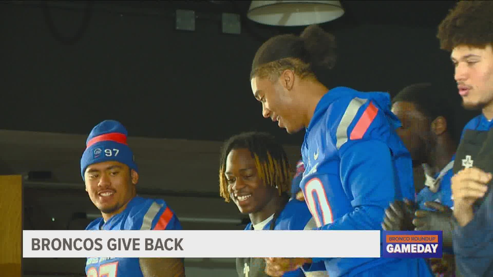 The annual event provides a hot meal for people who need a little help during the holidays. Boise State players offered a helping hand, plus on-stage entertainment.