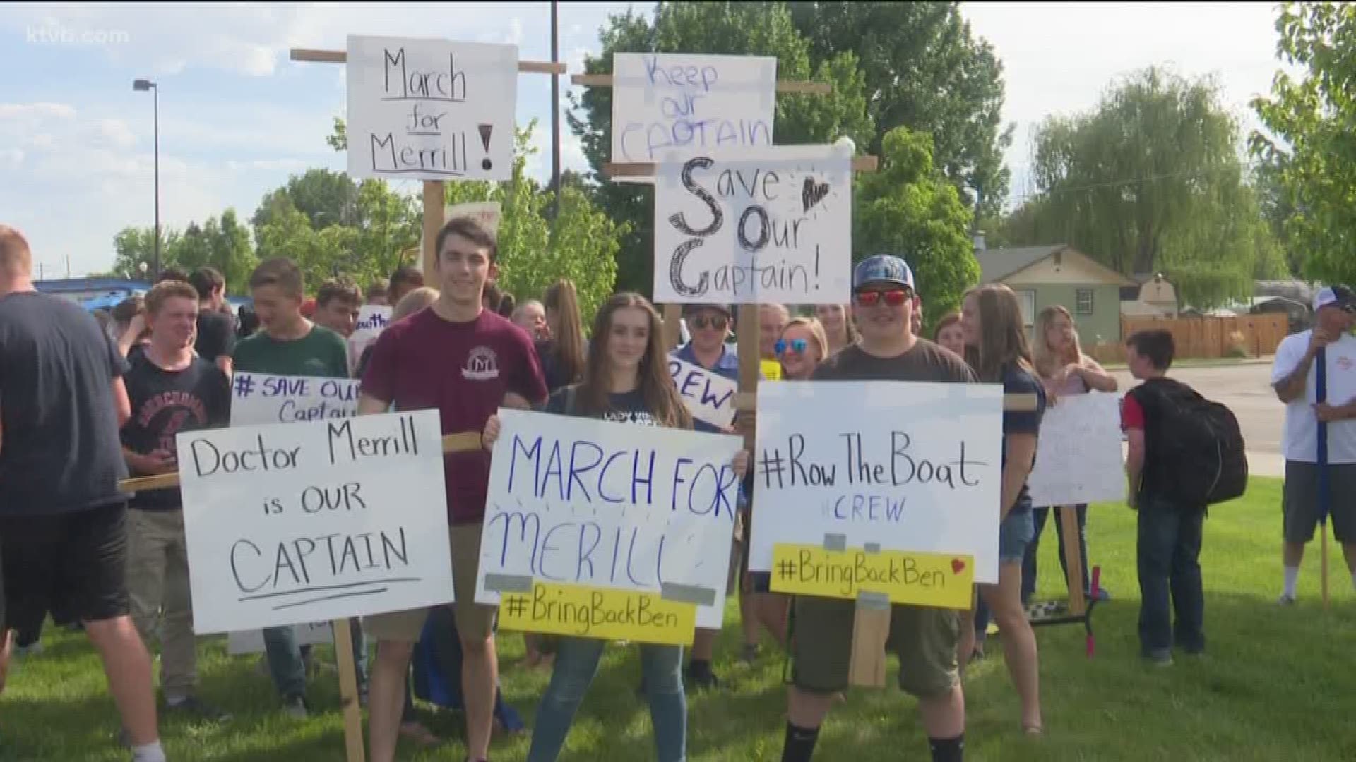 Dozens of students, many carrying signs in support of Middleton High School Principal Ben Merrill, marched to Monday night's school board meeting in an effort to get him reinstated.