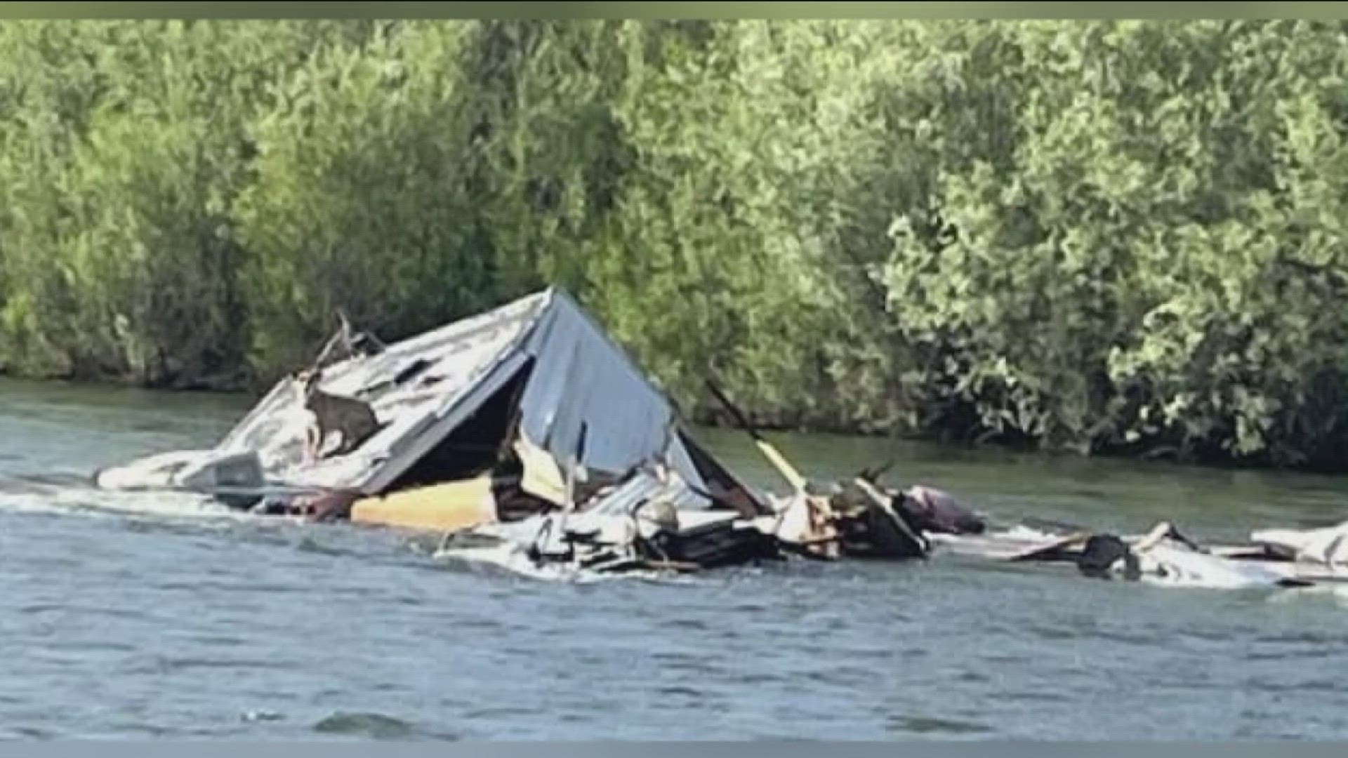 His pickup, camper and trailer fell off the road and into the river.