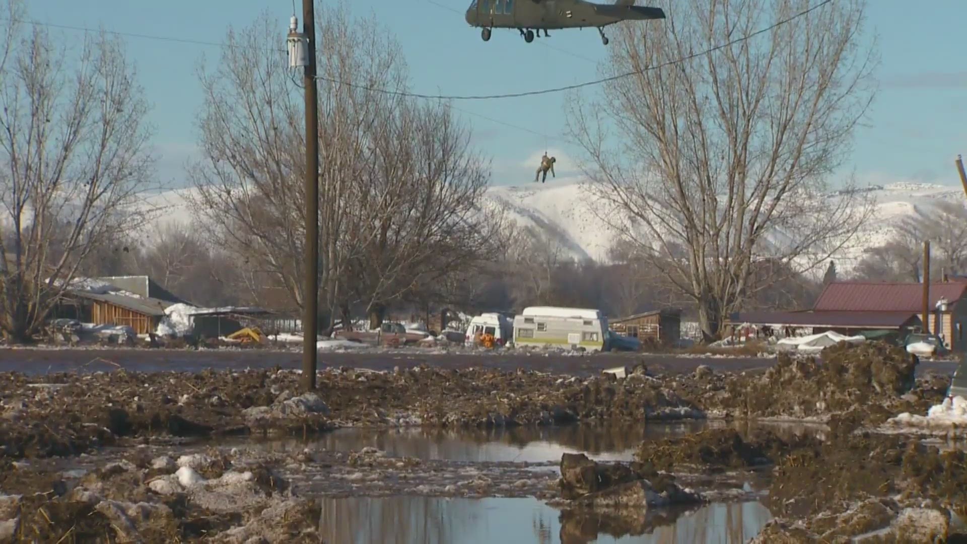 The Idaho Army National Guard UH-60 Blackhawk helicopter and crew flew over the house after 2 p.m., hovering low enough to allow several emergency responders to jump out into the water near the man's property.