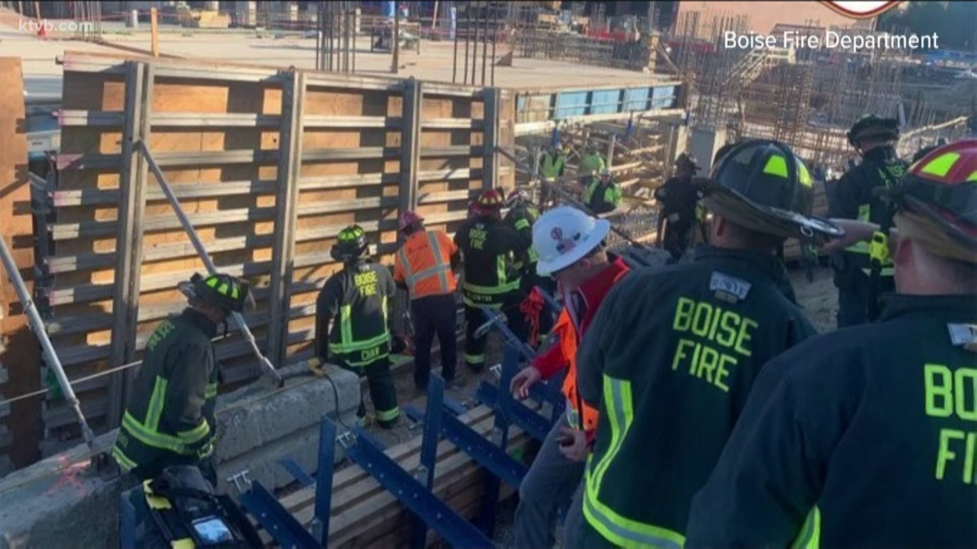 The worker's foot was pinned under a 2,000 pound retaining wall, officials said.