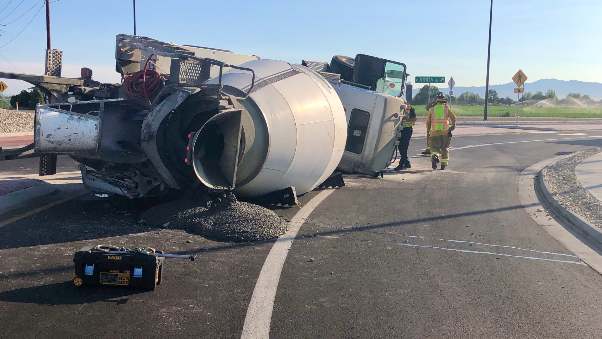 Driver taken to hospital after truck overturns in roundabout near ...