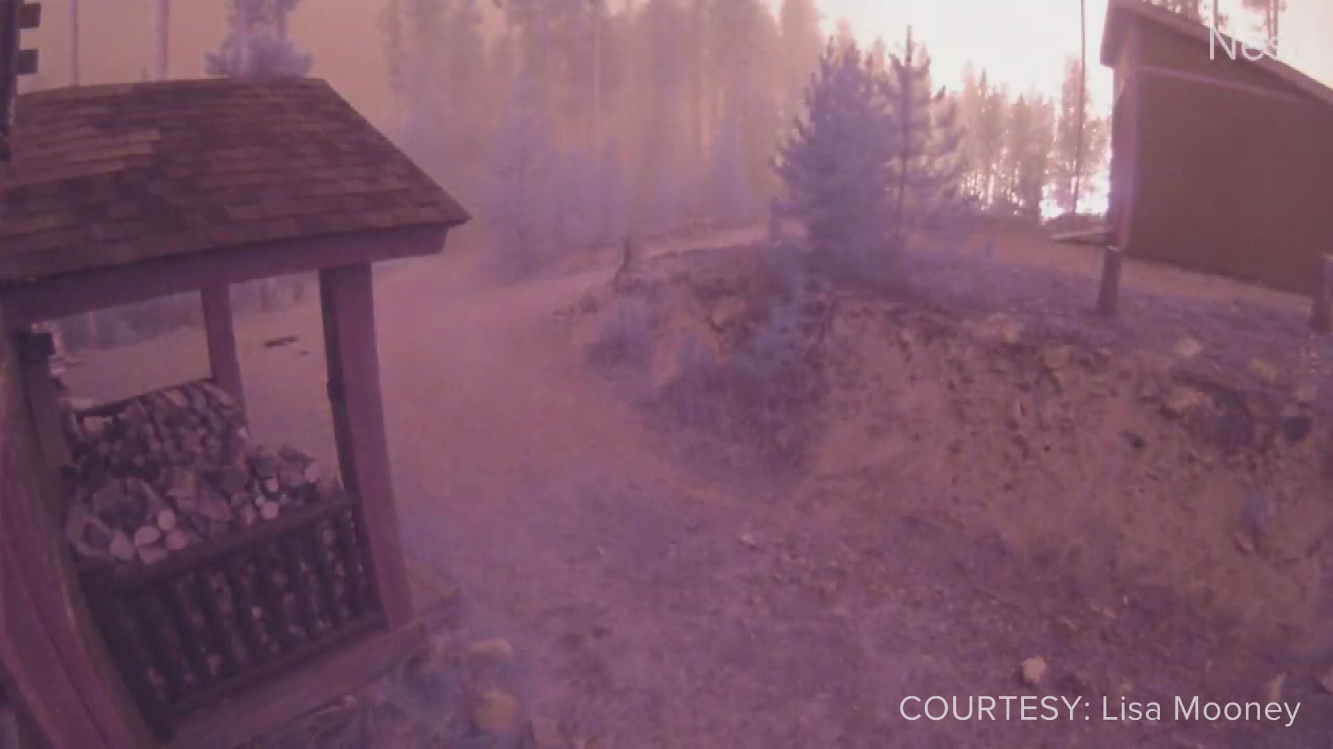 Video shared by Lisa Mooney show flames from the East Troublesome Fire creeping closer to her family's cabin in Grand Lake, Colorado on Wednesday night.