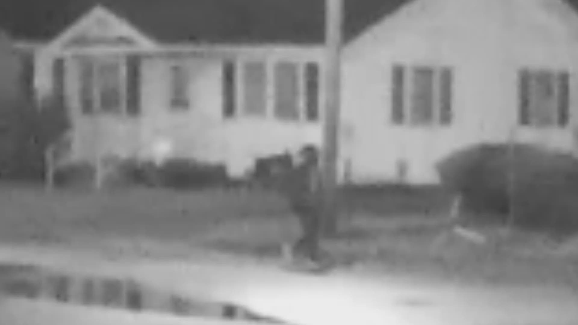 The video shows what appears to be a man wearing light colored shoes, a light-colored shirt, and a hoodie walking toward the Rosewood Mobile Home Park in Lumberton, N.C.